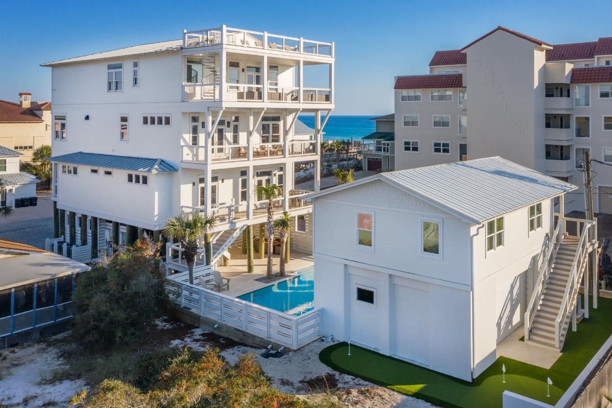 Off The Hook multi-family vacation home exterior with pool, guest house, and rooftop deck in Miramar Beach